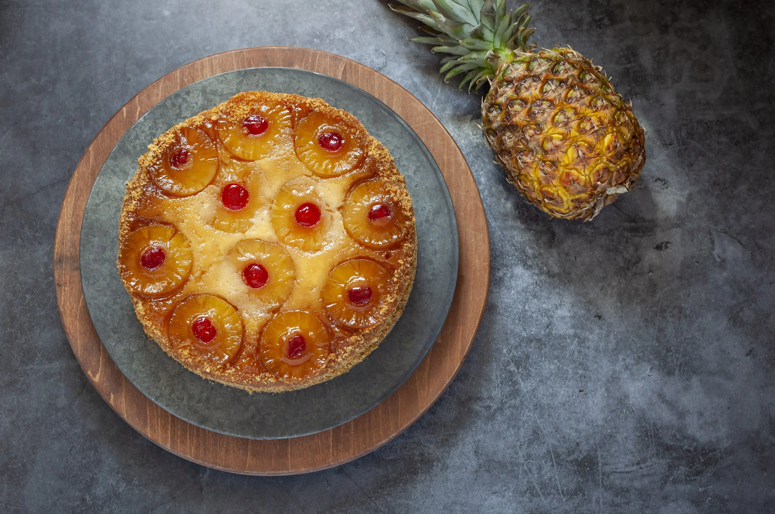  GOURMET PINEAPPLE UPSIDE DOWN CAKE:  A Spring and Summer special, traditional moist yellow sponge cake baked and topped with pineapple rings and candied cherries. The cake is also baked with a brown sugar topping and finished with a sweet glaze. Ser