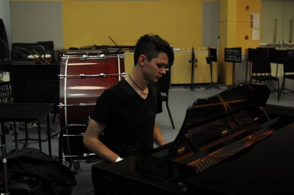 Sterling Chambers sitting at a piano. Photo courtesy of Joan Holubeck.