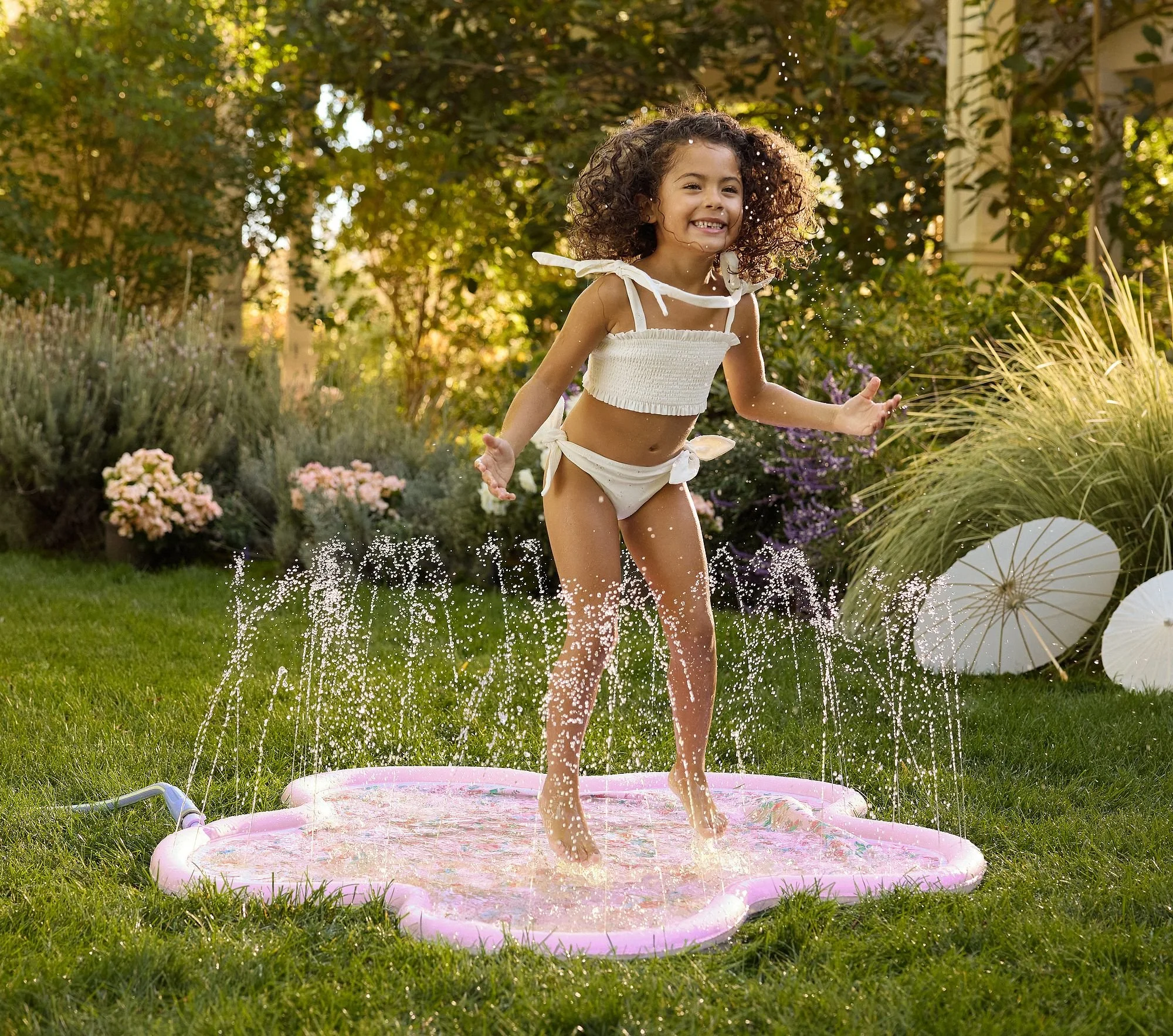 loveshackfancy-flower-shaped-inflatable-splash-pad-xl.jpg