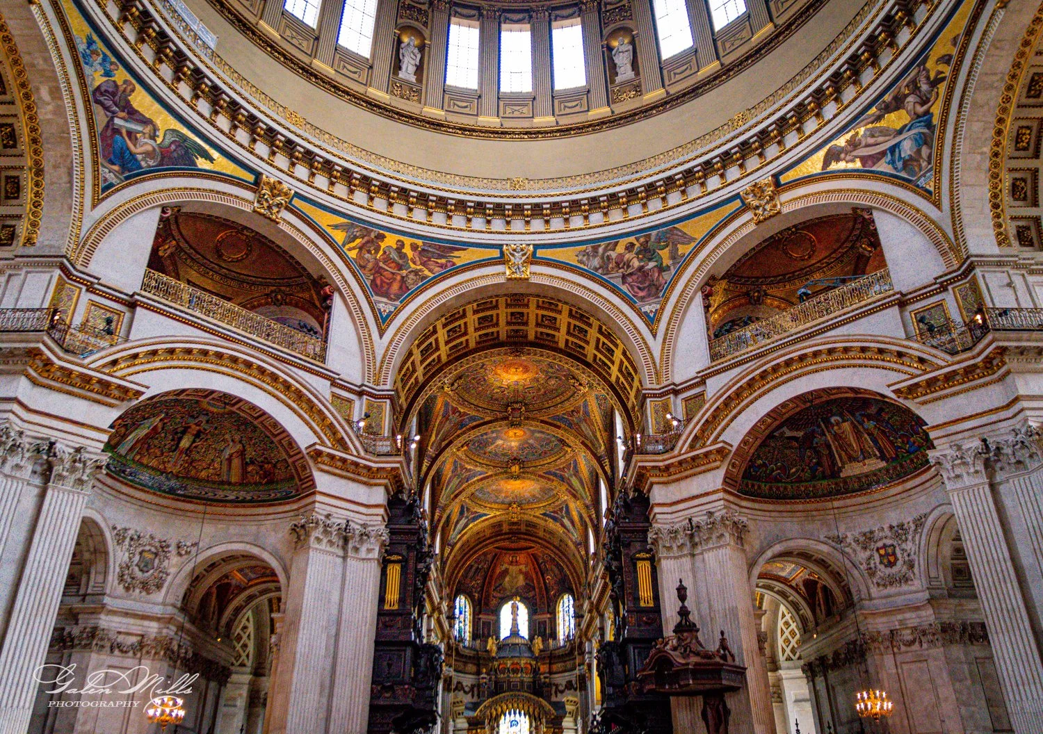 Interior view of St. Paul's Cathedral in London, showcasing ornate arches, domed ceiling, and colorful mosaics.