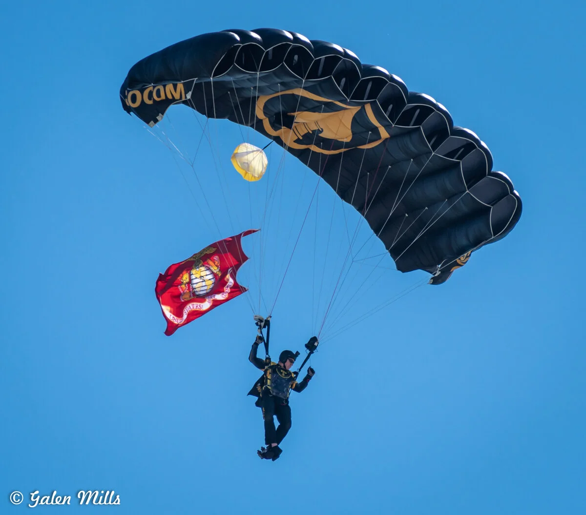 Skydiver with US Marine Corps flag descending