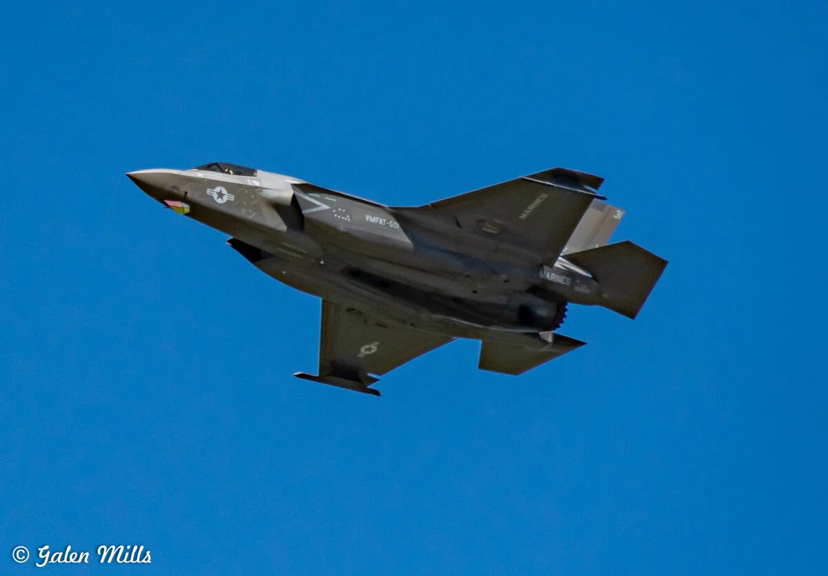 F-35 fighter jet flying in clear blue sky