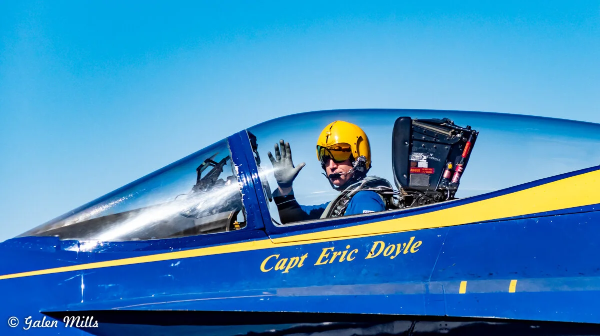 Pilot waving from cockpit of a Blue Angels jet