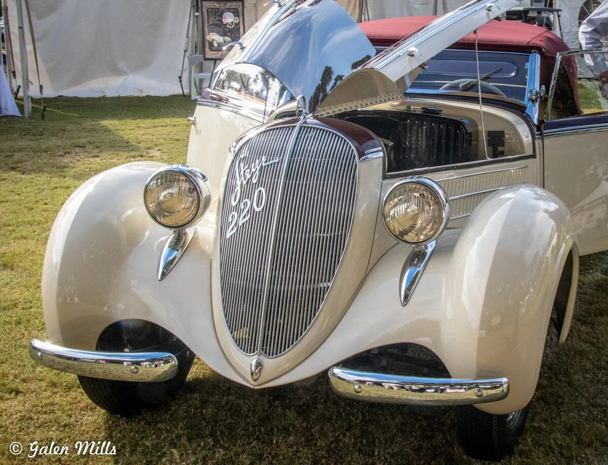Vintage Steyr 220 car with hood open at auto show