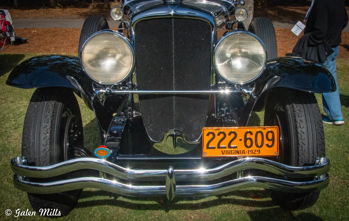Front view of a vintage car with a 1929 Virginia license plate, featuring a chrome grille and headlights.