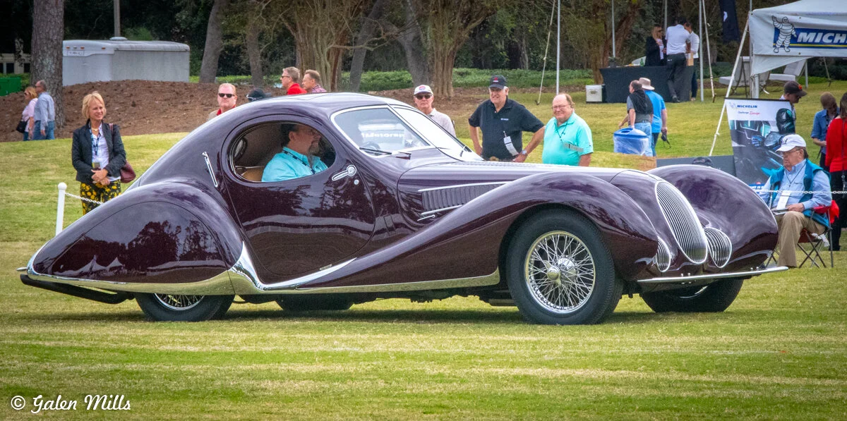 Vintage Talbot-Lago car at a car show with spectators in the background.