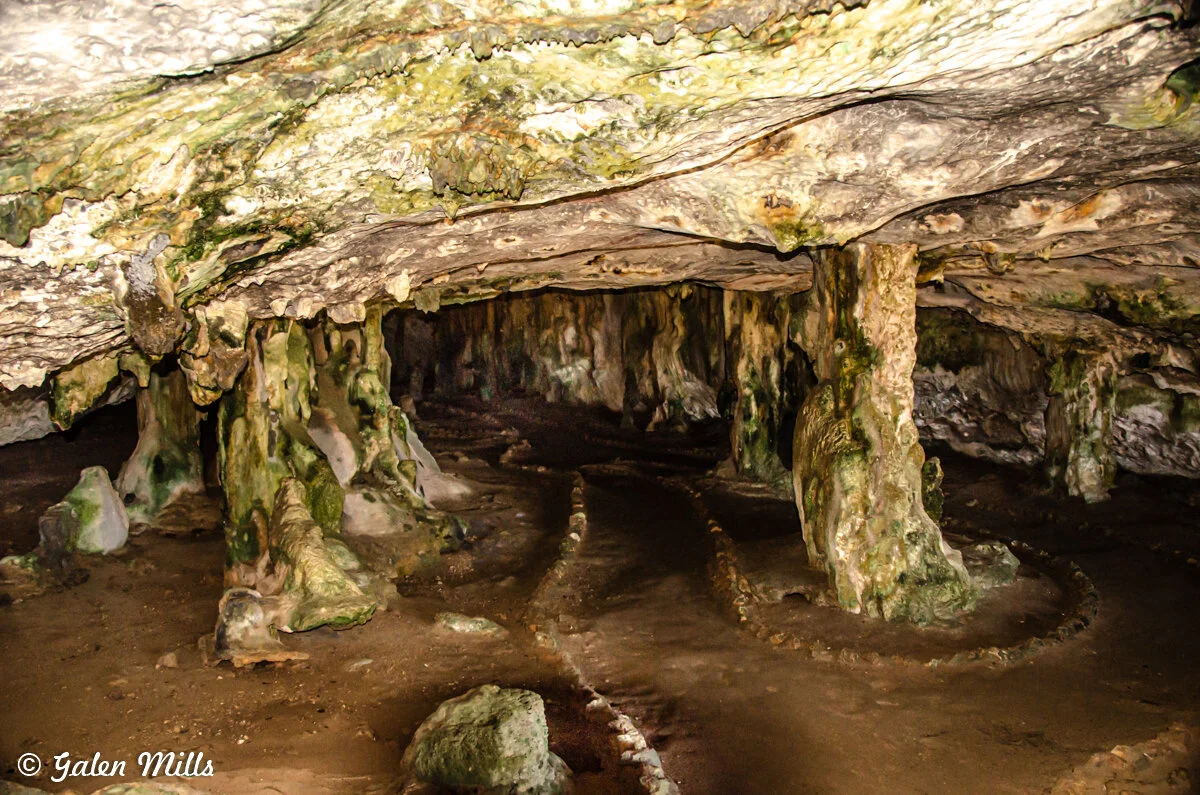 Interior of a natural limestone cave with stalagmites and stalactites.