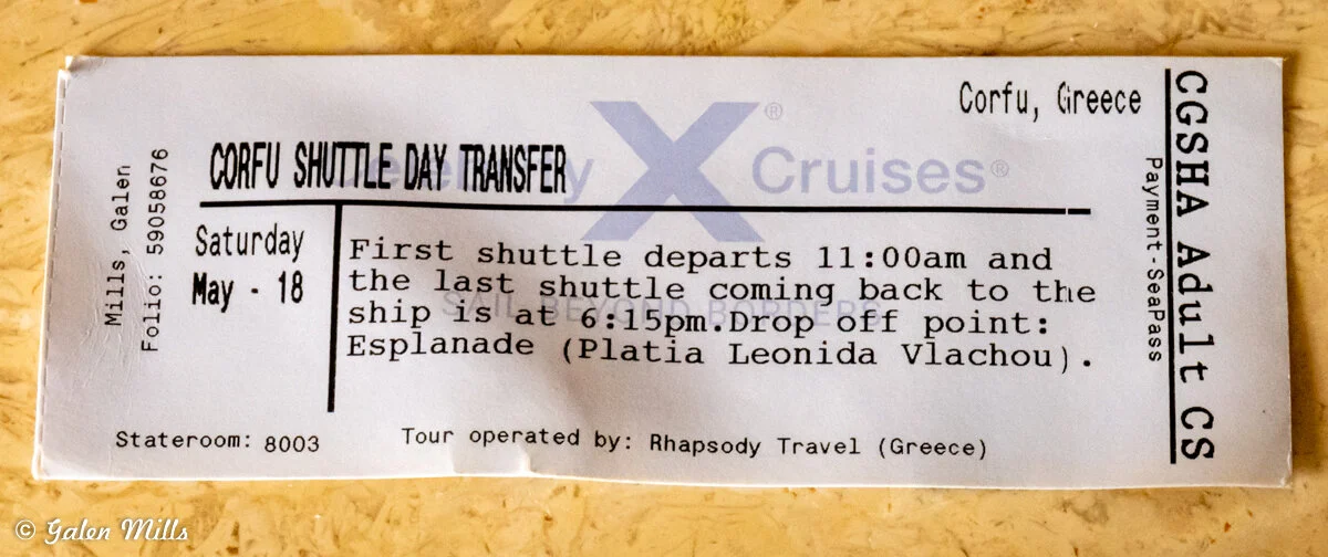 Ticket for a shuttle transfer in Corfu, Greece, showing details like departure time, shuttle schedule, drop-off point, stateroom number, and tour operator information.