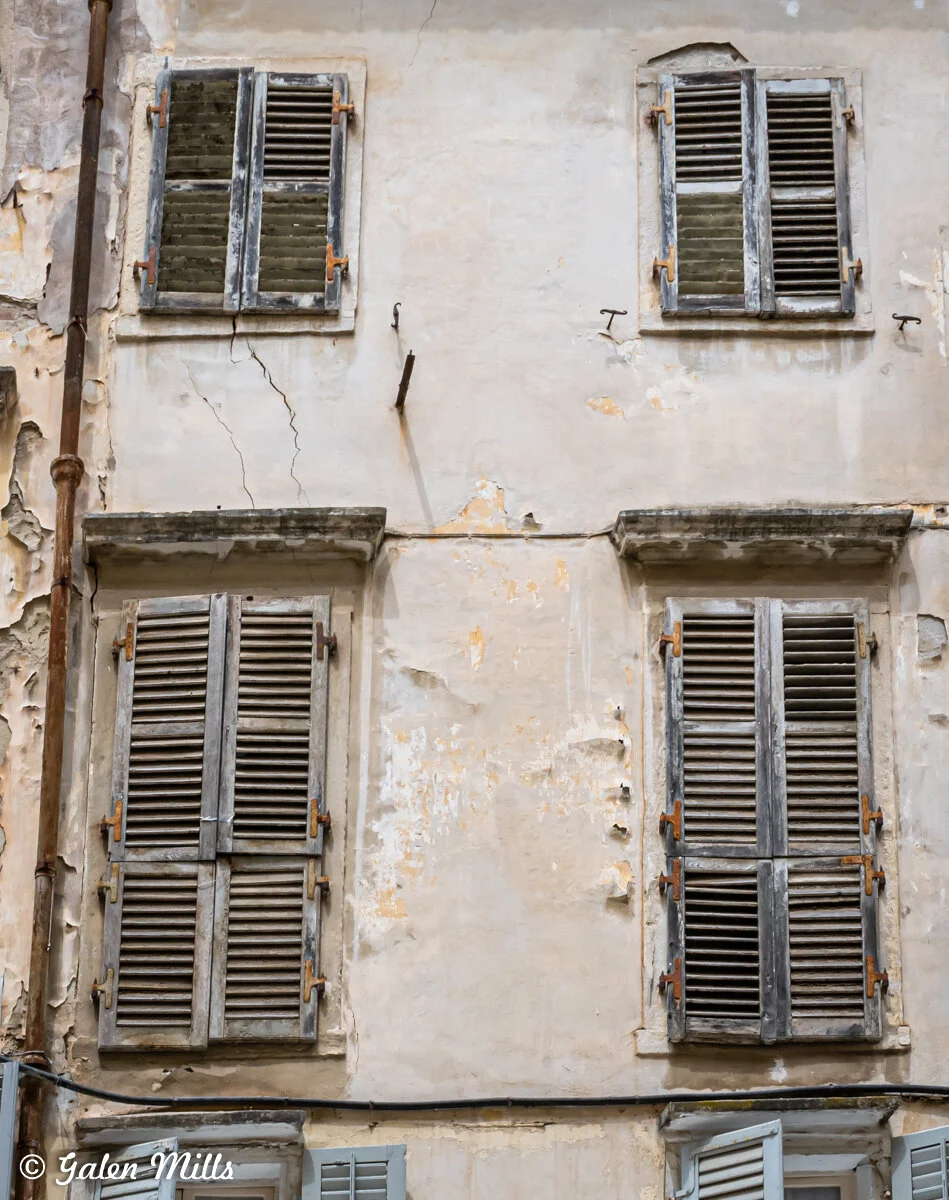 Old building facade with weathered shutters