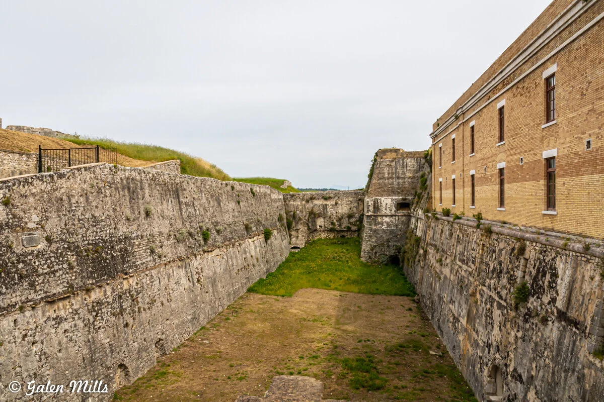Old stone fortress with grassy moat and brick building