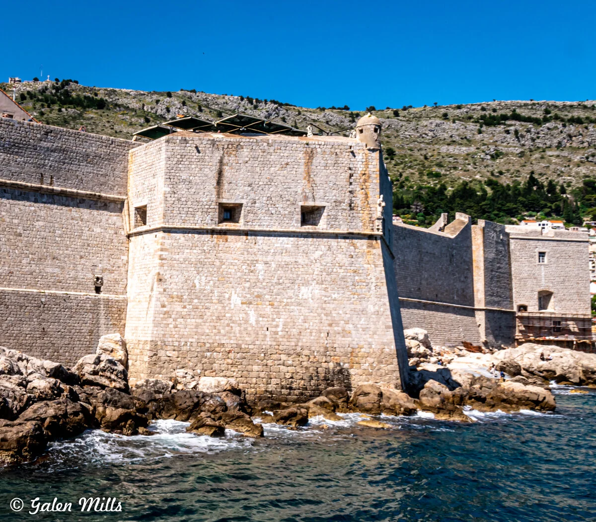 Ancient stone fortress by the sea with surrounding rocky shoreline
