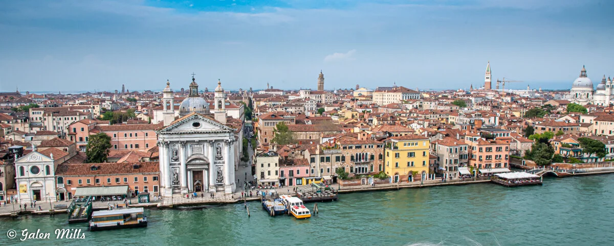 Aerial view of Venice, Italy, showing historic architecture, a canal, and San Giorgio Maggiore church.