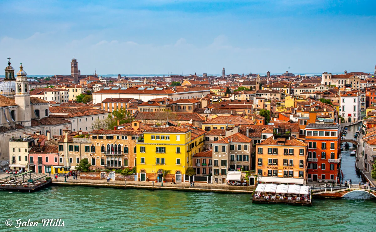 Aerial view of colorful buildings and a canal in Venice, Italy.