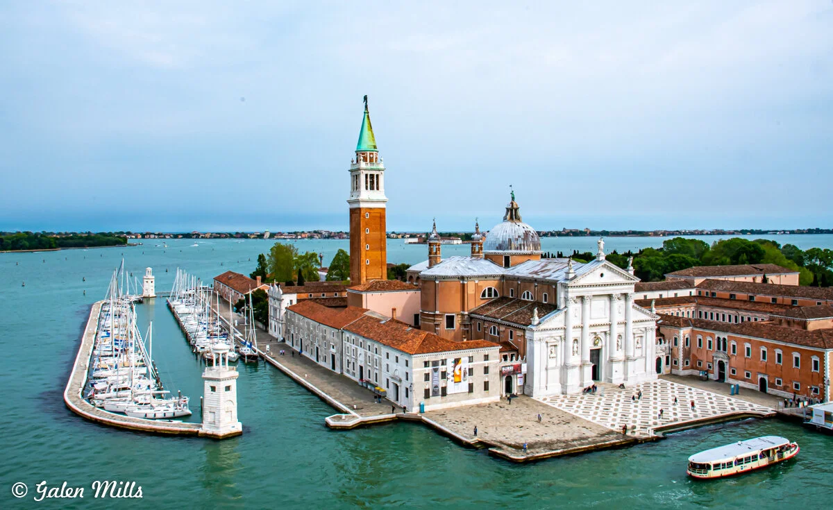 Scenic view of San Giorgio Maggiore Island in Venice, Italy, featuring the church with its iconic bell tower and surrounding waterfront.