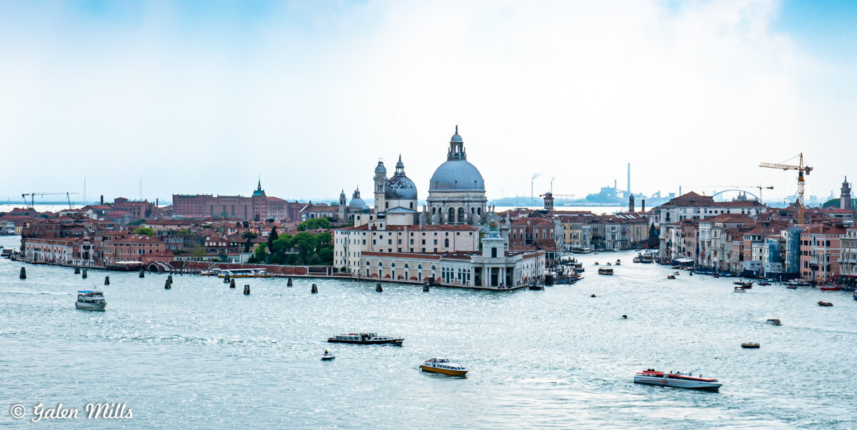 Venice Grand Canal with Basilica di Santa Maria della Salute and boats in Italy.