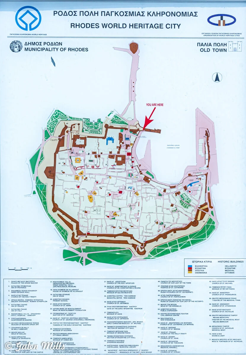 Map of Rhodes Old Town, displaying historic buildings and points of interest. Includes markers for Hellenistic, Byzantine, and Ottoman structures, with a 'You Are Here' indicator. Contains a legend and lists of key sites.