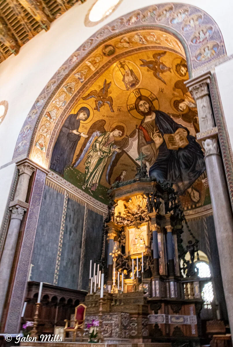 Ornate church interior with religious mosaic and altar