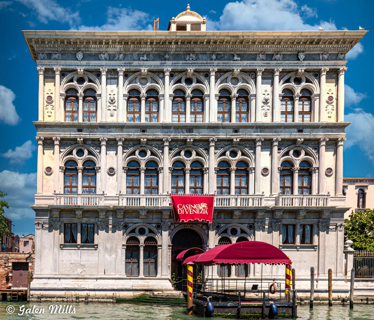 Historic building Casino di Venezia on the Grand Canal, Venice with ornate facade and red awning.