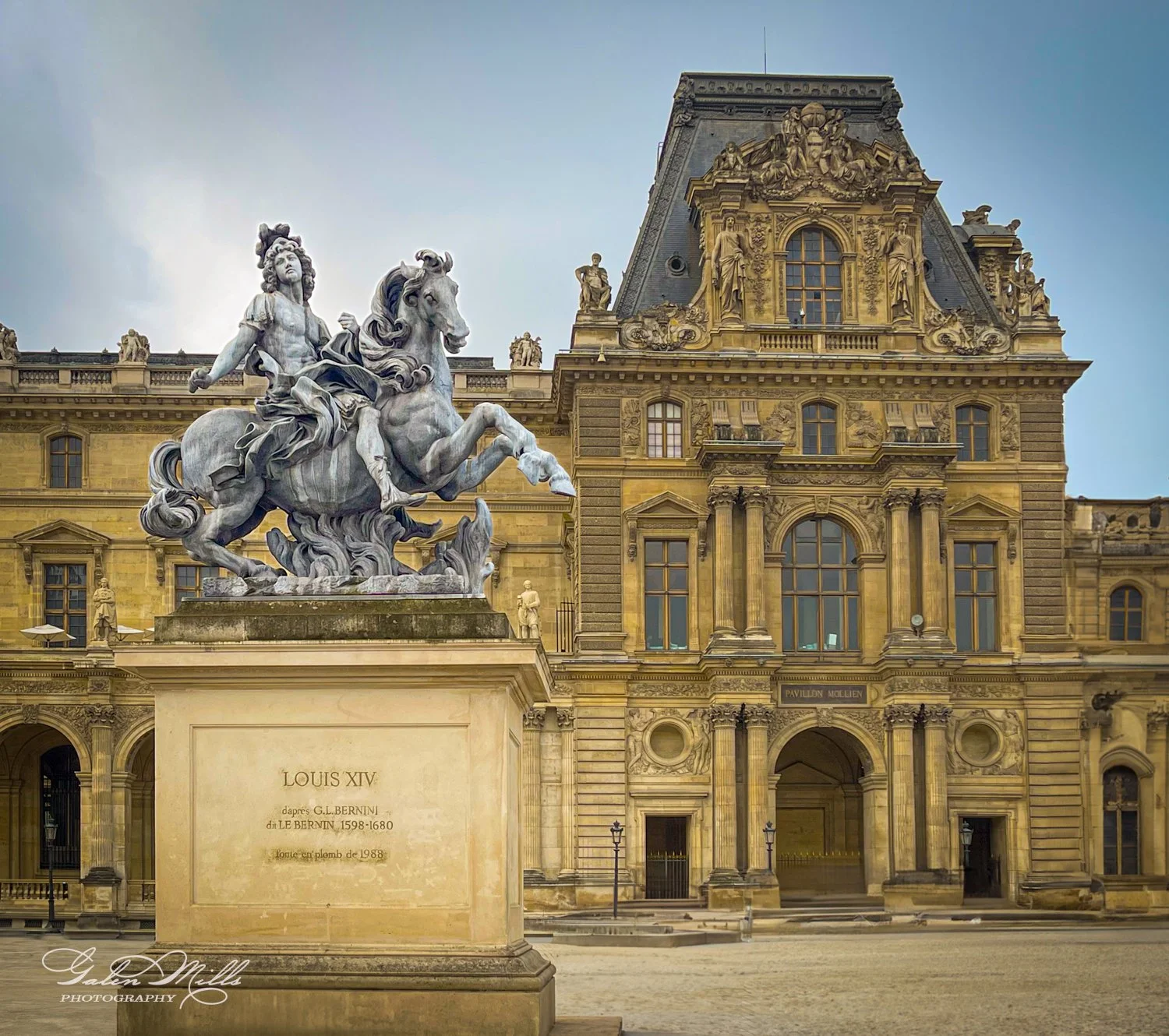 Equestrian statue of Louis XIV in front of the Louvre Museum's Pavillon Mollien entrance, Paris, France.