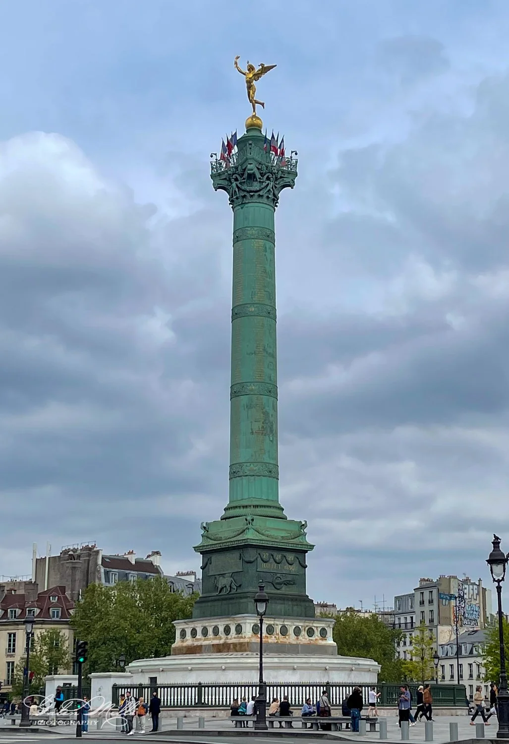 July Column in Place de la Bastille, Paris, with a golden statue on top and surrounding buildings.