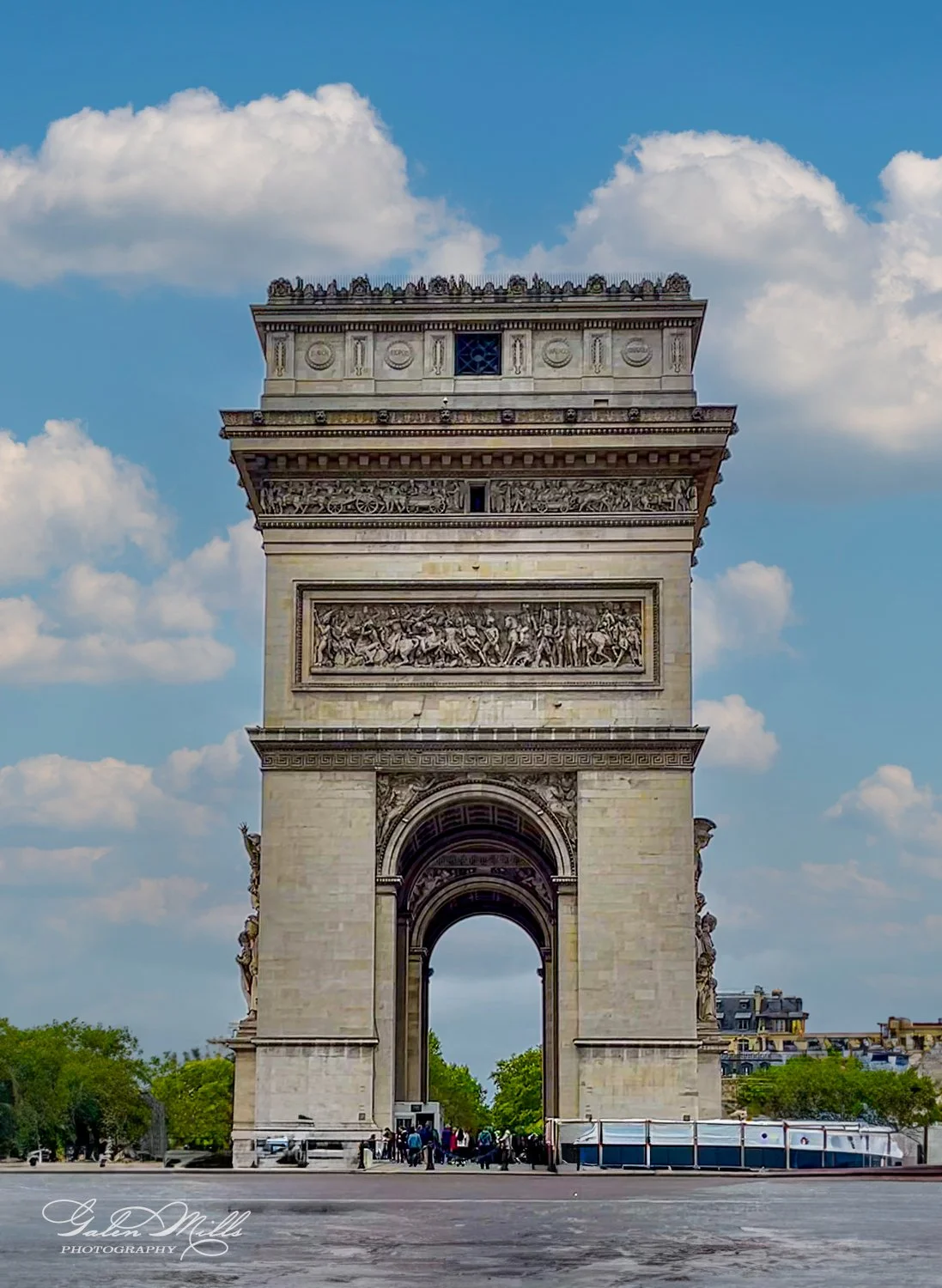 Arc de Triomphe in Paris, France, with blue sky and clouds.