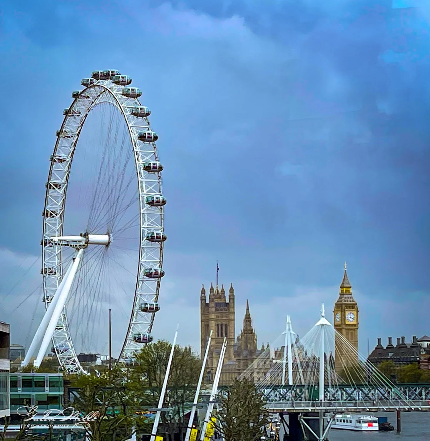 London cityscape featuring the London Eye, Big Ben, and Westminster buildings under a cloudy sky.