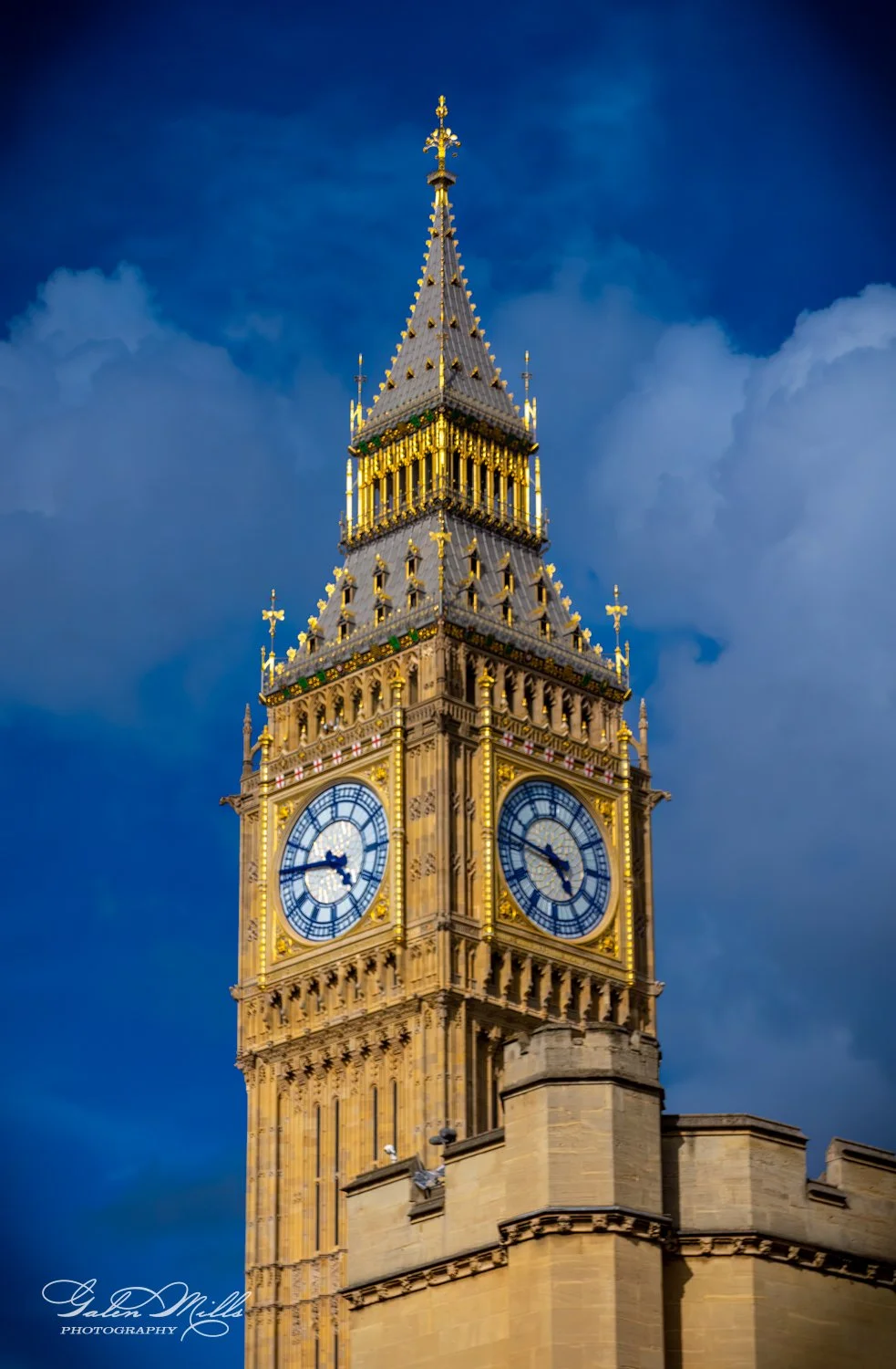Big Ben a Clock tower with ornate design against a cloudy blue sky