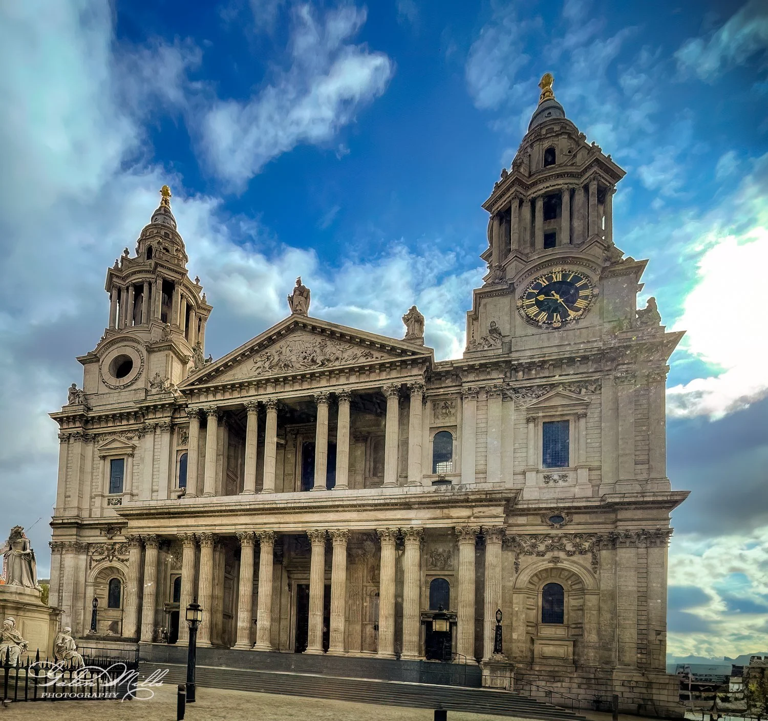 Facade of St. Paul's Cathedral, London, with blue sky background.