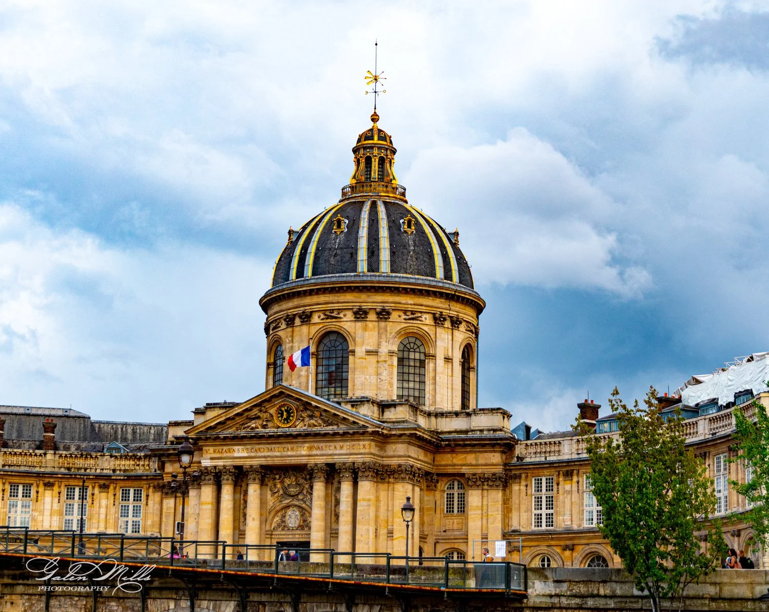 Historic building with dome and French flag in Paris