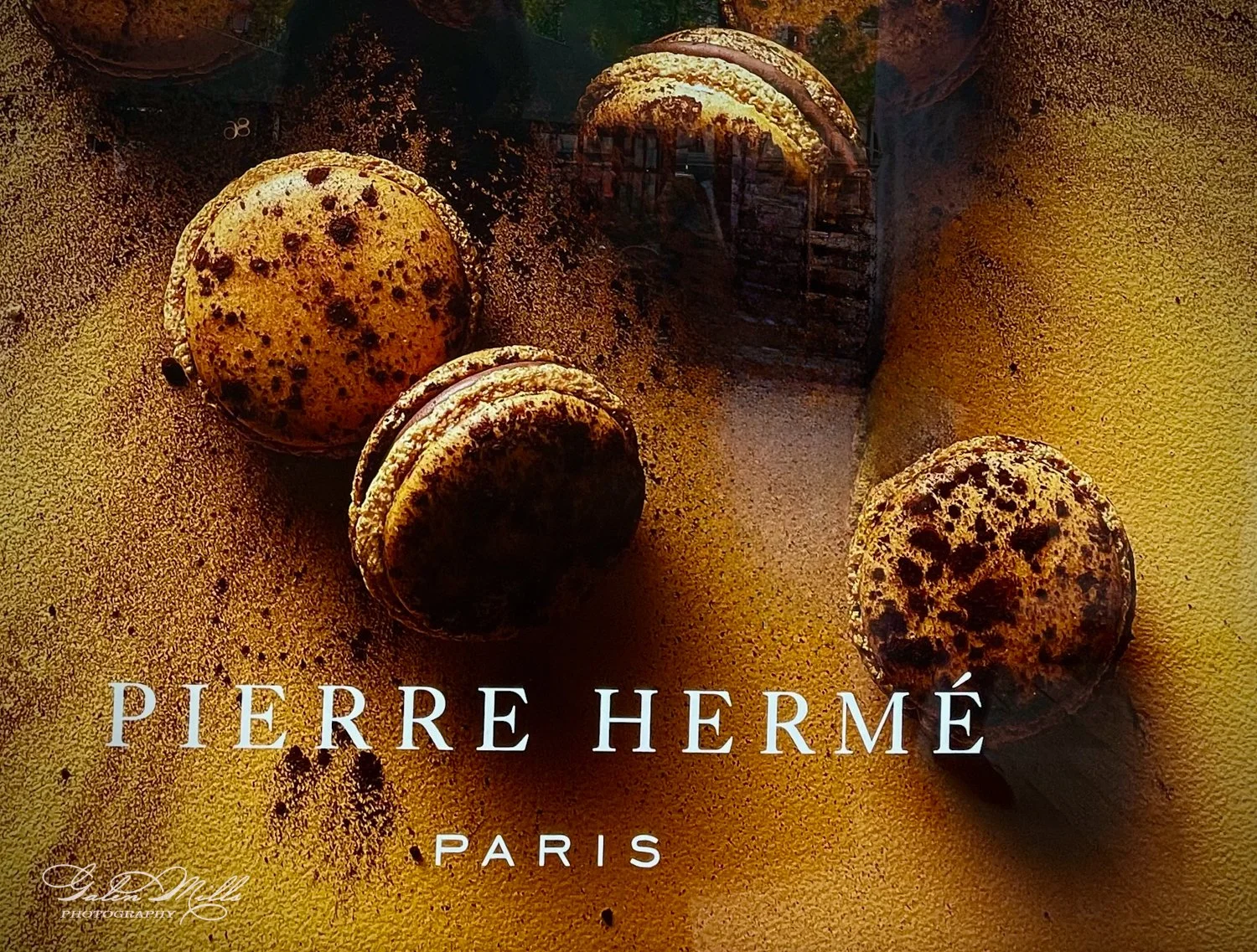 Macarons with chocolate speckles, branded Pierre Hermé Paris.