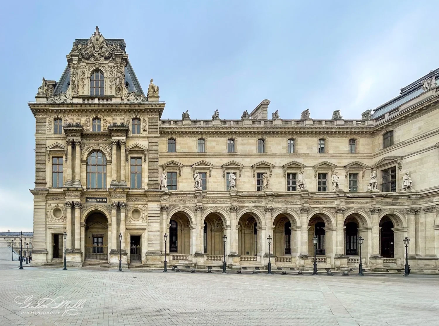 Exterior view of the Louvre Museum with architectural details.