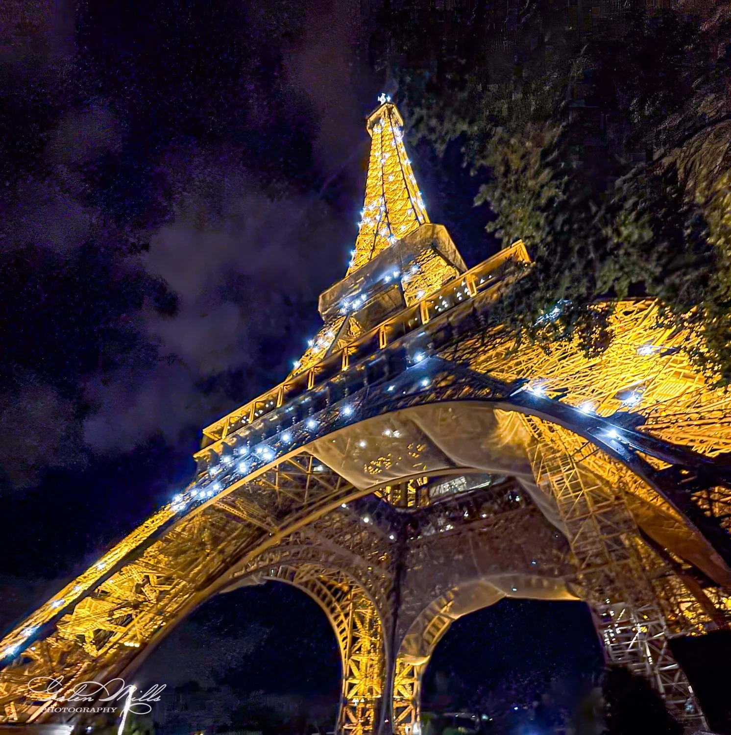 Eiffel Tower illuminated at night with dark sky