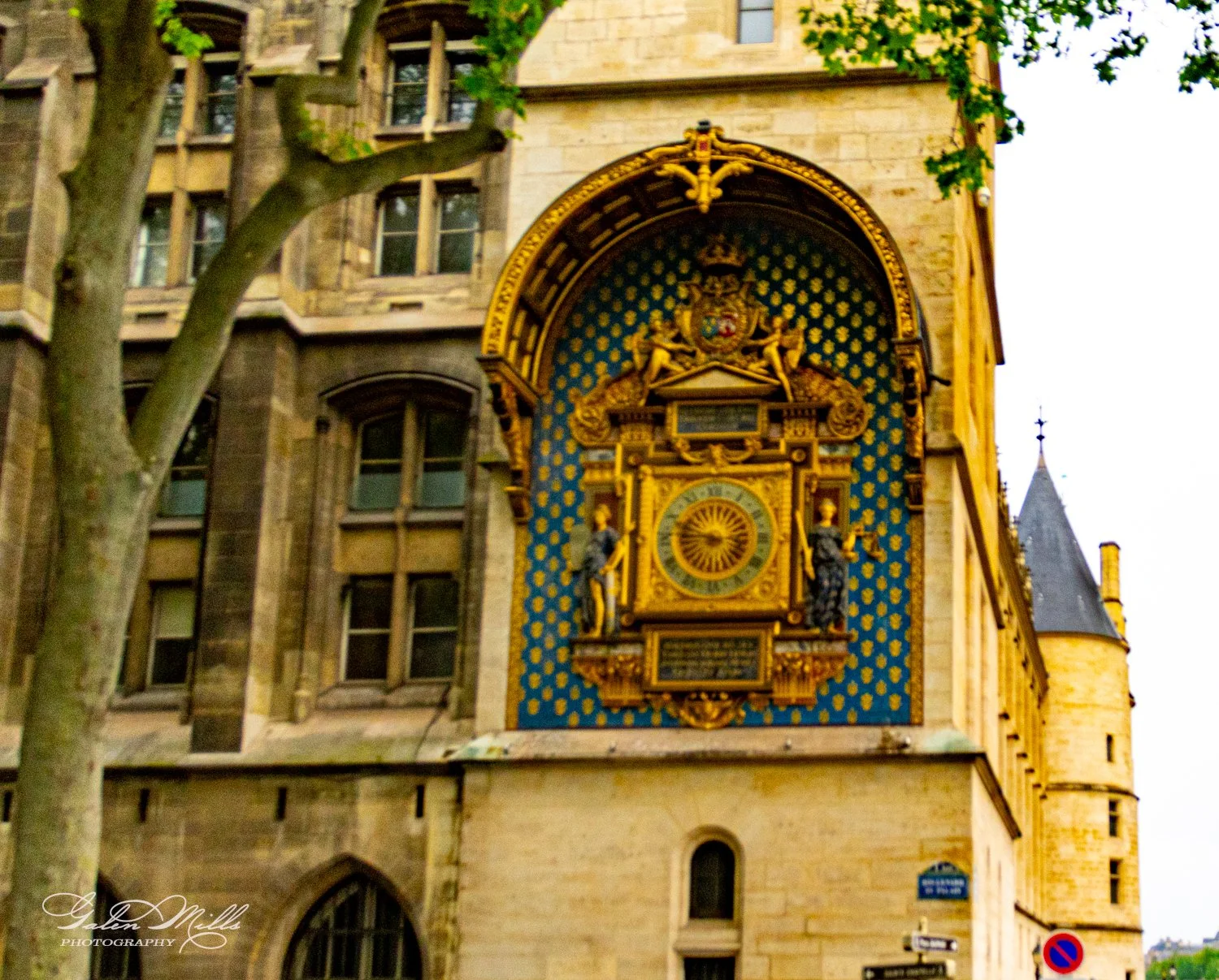 Ornate clock on historic building exterior, Paris
