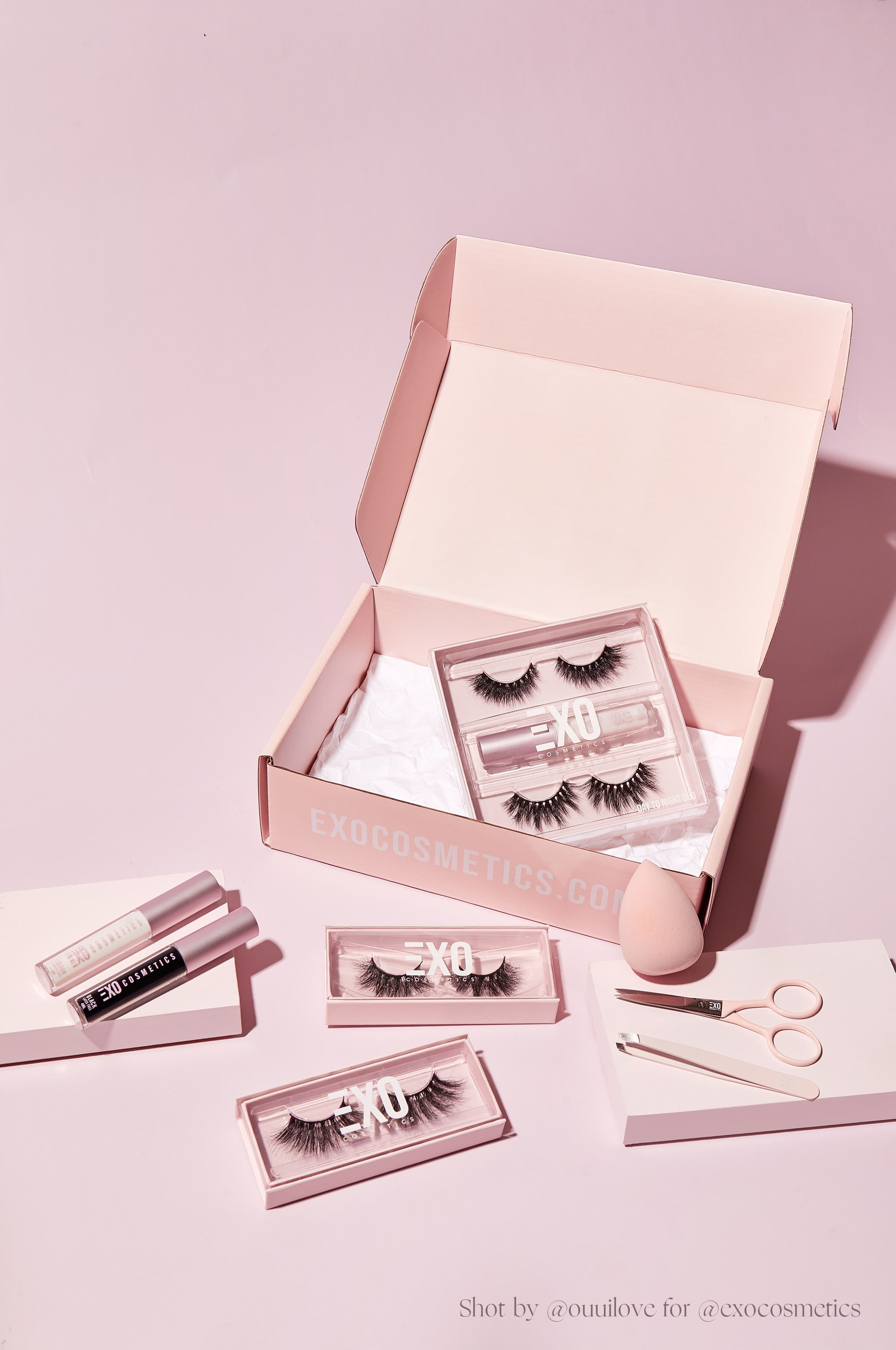 Want to Open an Online Store? Here’s 5 Things to Consider: Exo Cosmetics lashes, mascara, and beauty tools sitting next to an open pink packing box.