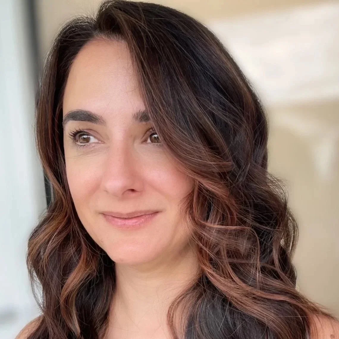 Soft brunette hair color with warm dimension by a Woodbridge, VA salon