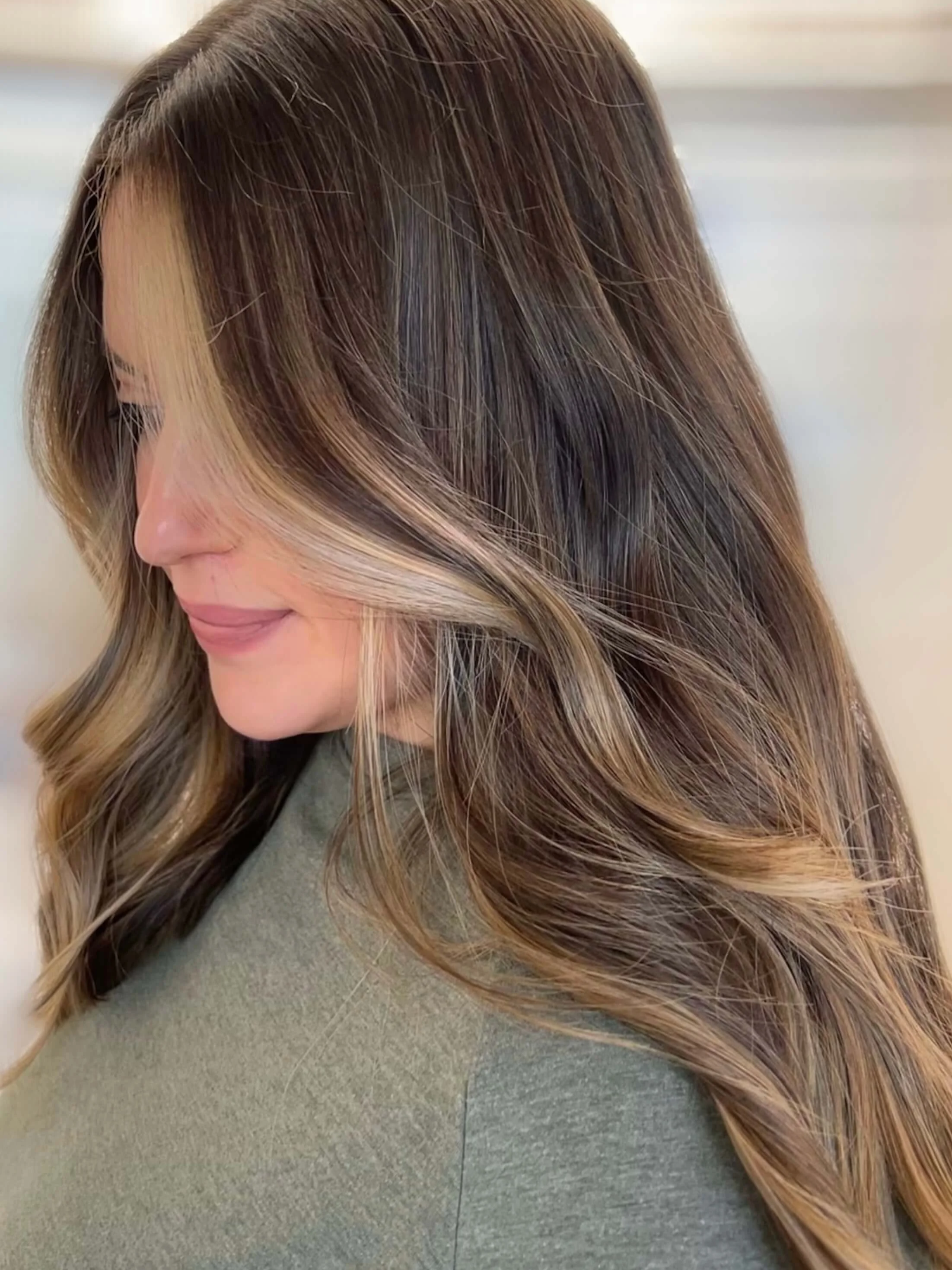 Soft dimensional brunette hair with blonde highlights by Kindred Color Studio in Woodbridge VA