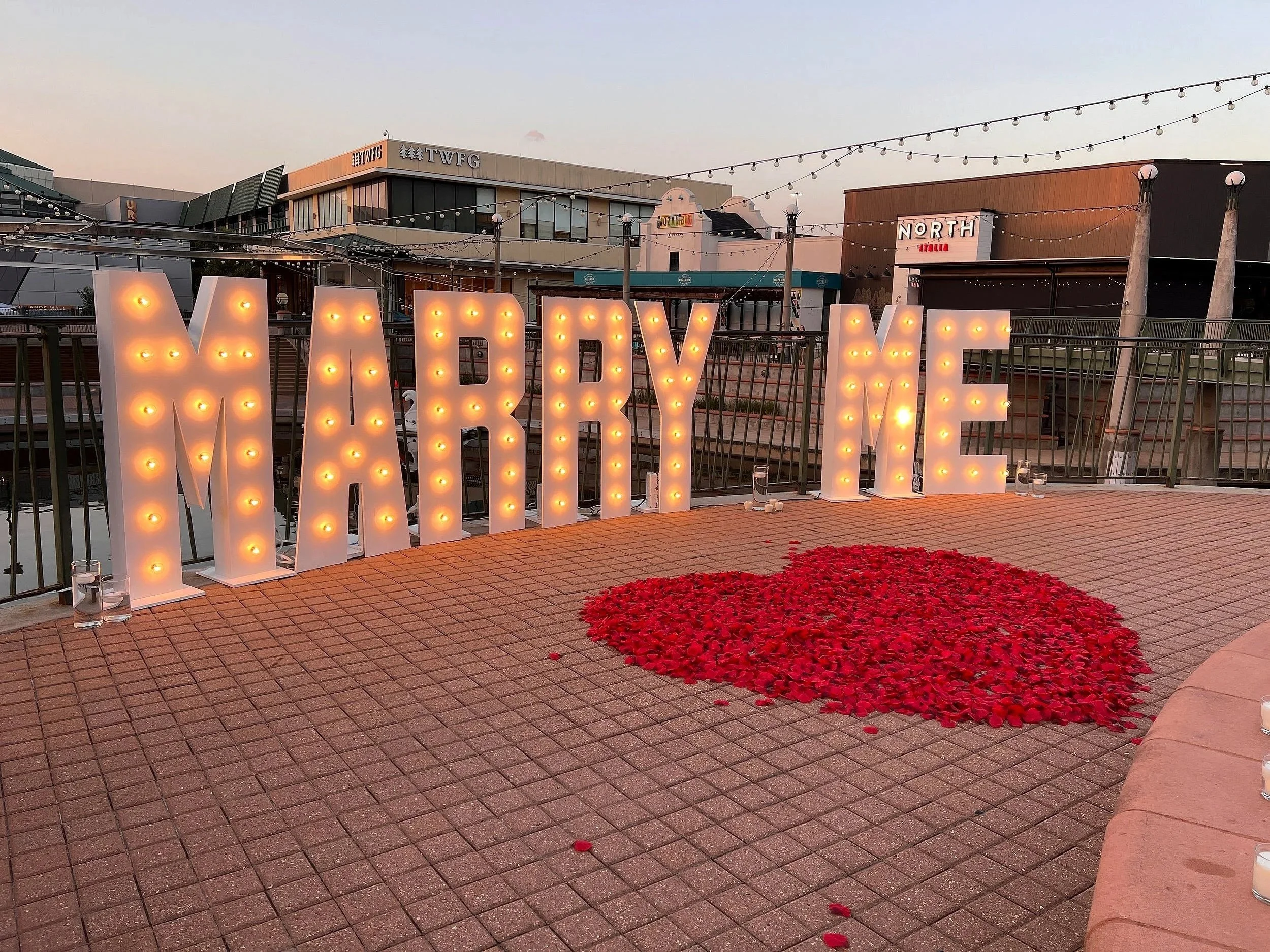 MARRY ME marquee letters with a rose petal heart for a proposal, The Woodlands