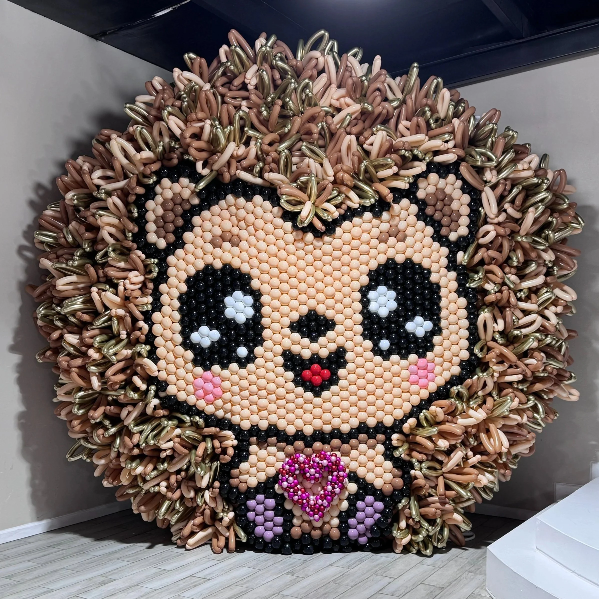 Sculptural balloon wall mural of a smiling hedgehog with a pink heart, The Woodlands
