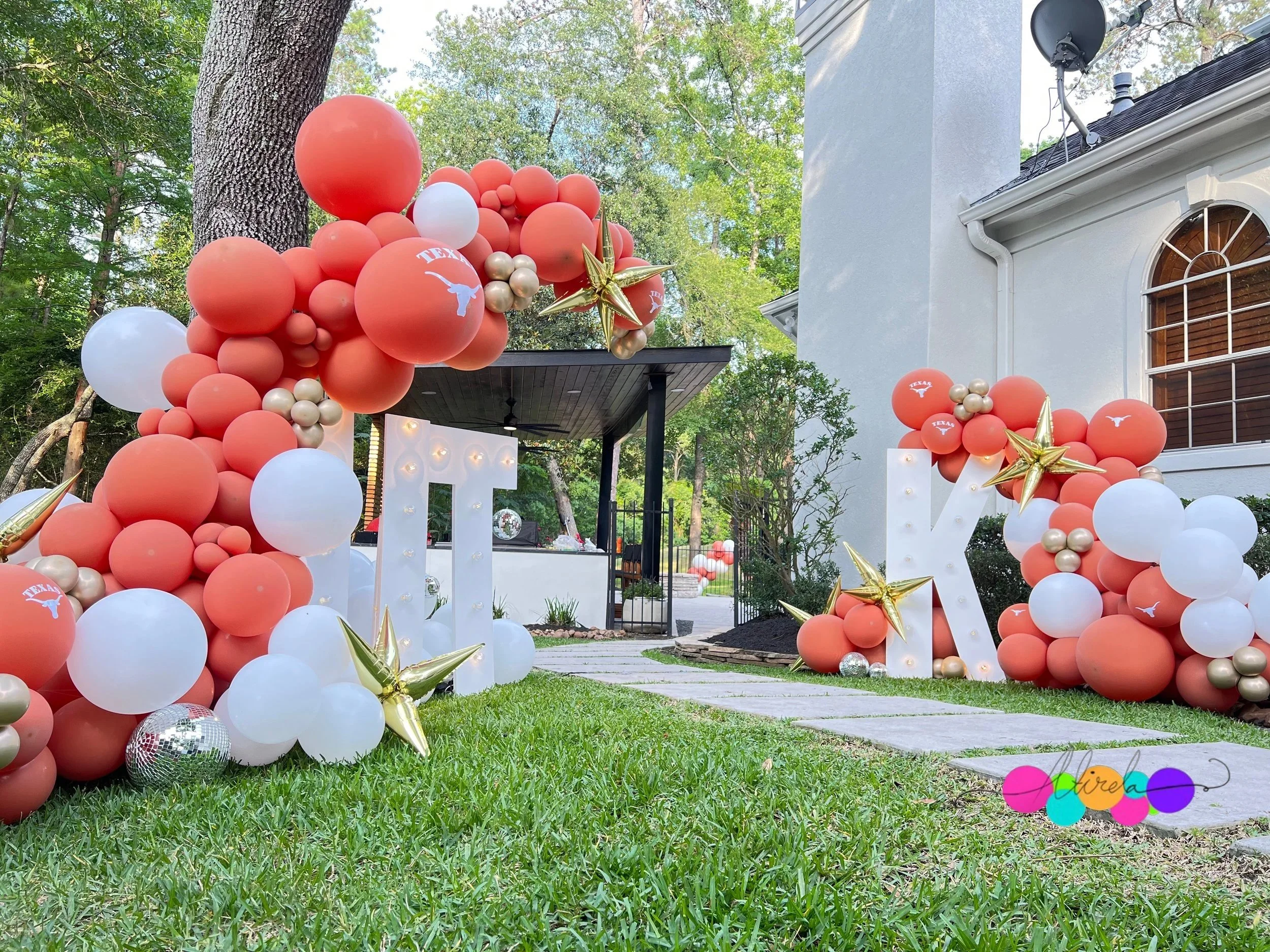 Graduation party with red, white and orange garland and marquee letters, The Woodlands