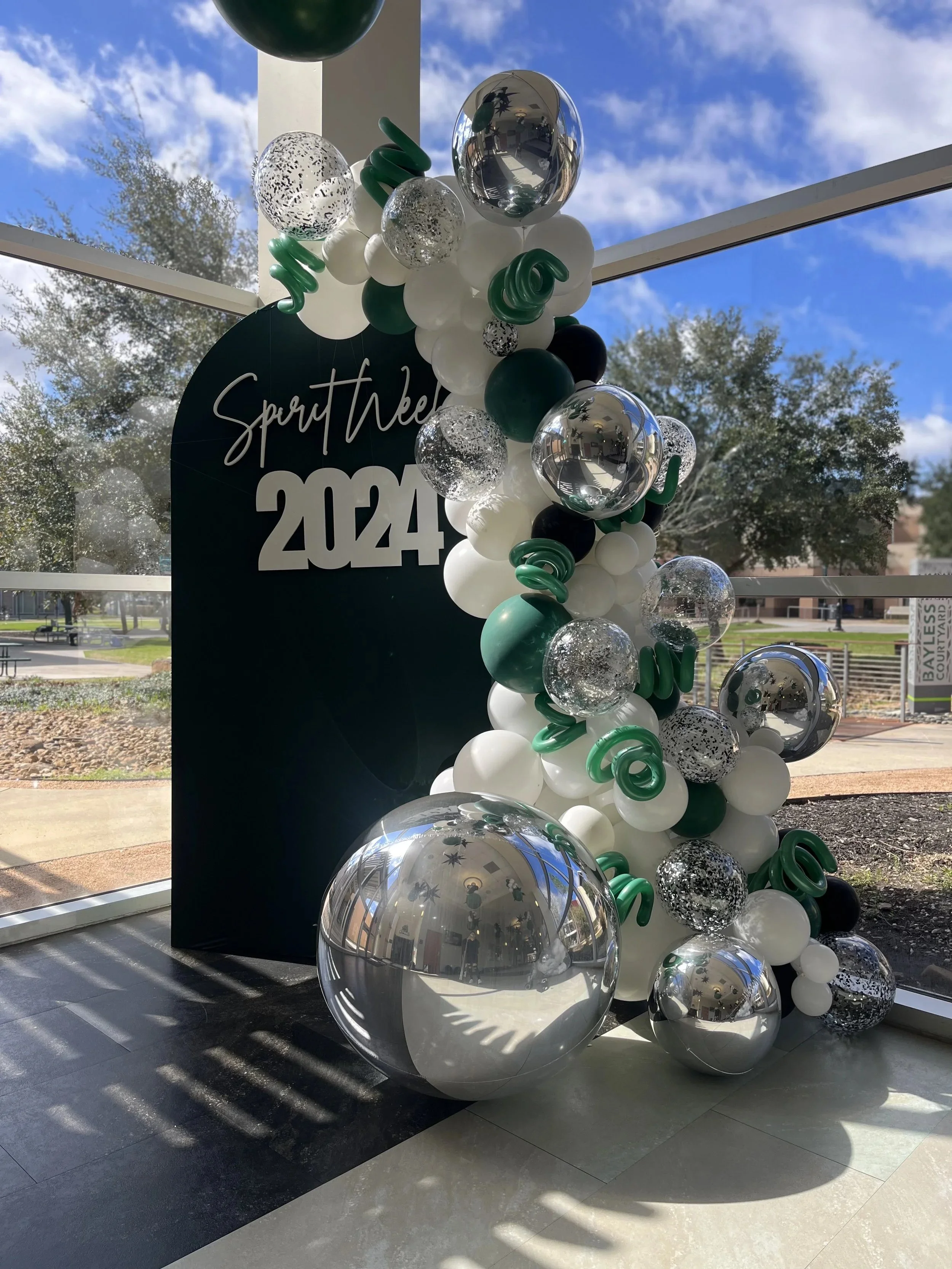 Green, silver and white balloon garland for a private school homecoming, The Woodlands