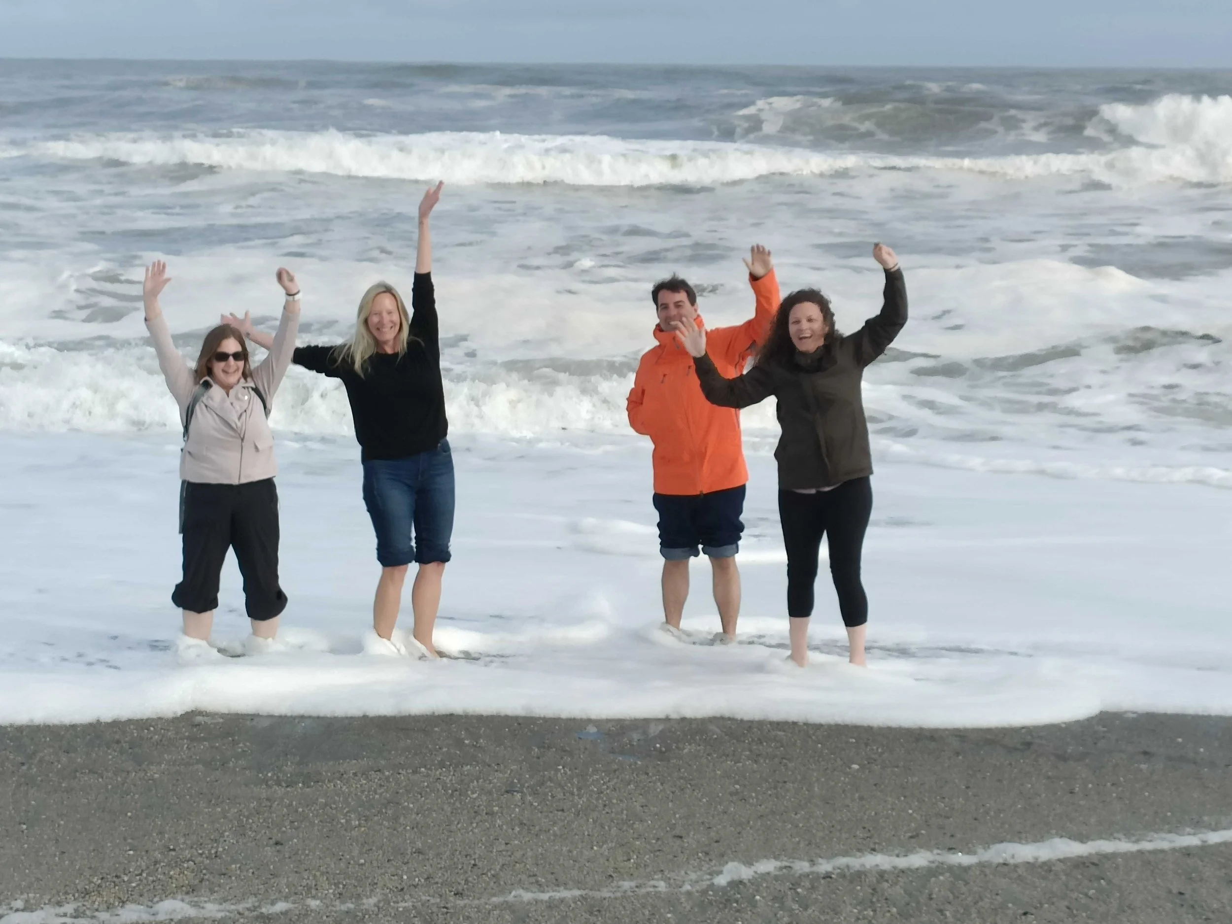 Four standing in the ocean in the Abel Tasman