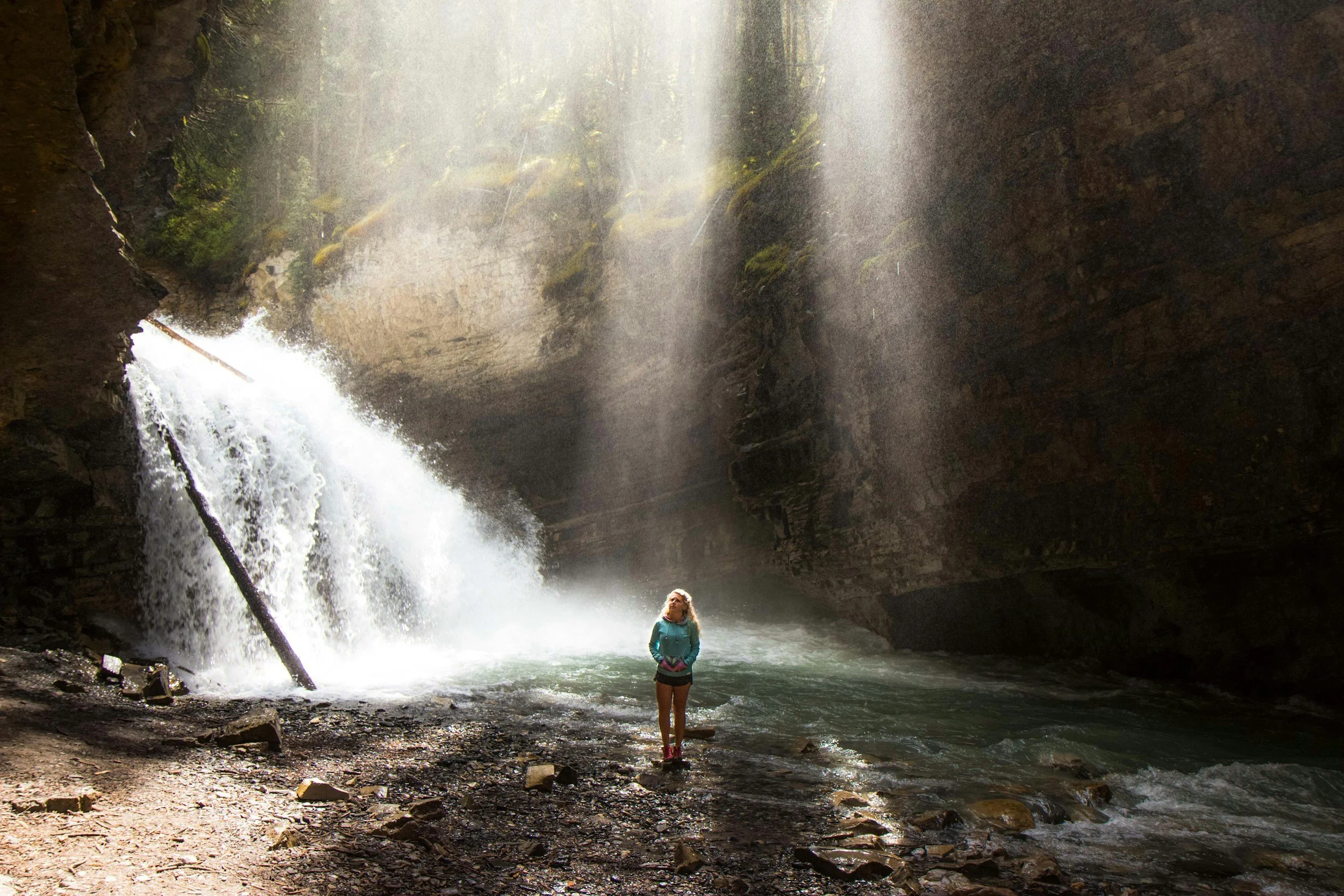 Lady pondering at waterfall
