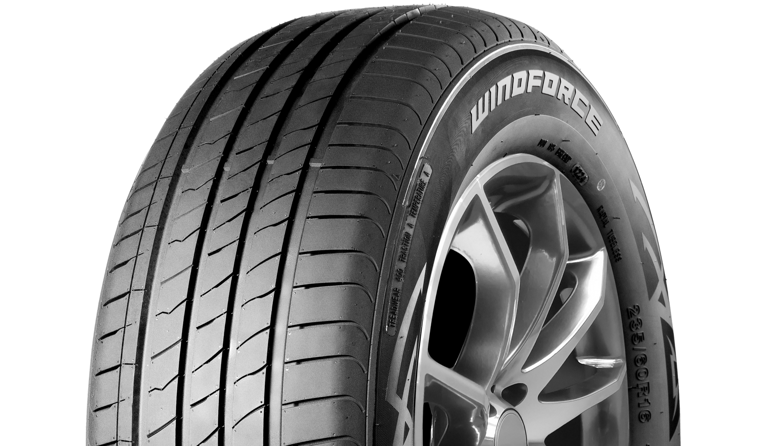 Close-up black and white image of a car tire with the brand name 'Windforce' visible on the sidewall, mounted on a silver alloy wheel.