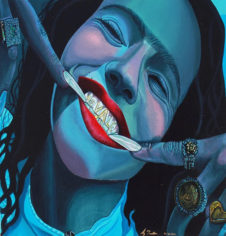 A latina woman smiles brightly with her red lipstick and her grill saying "Me Vale". Her two pointer fingers point to her teeth while she wears big rings.