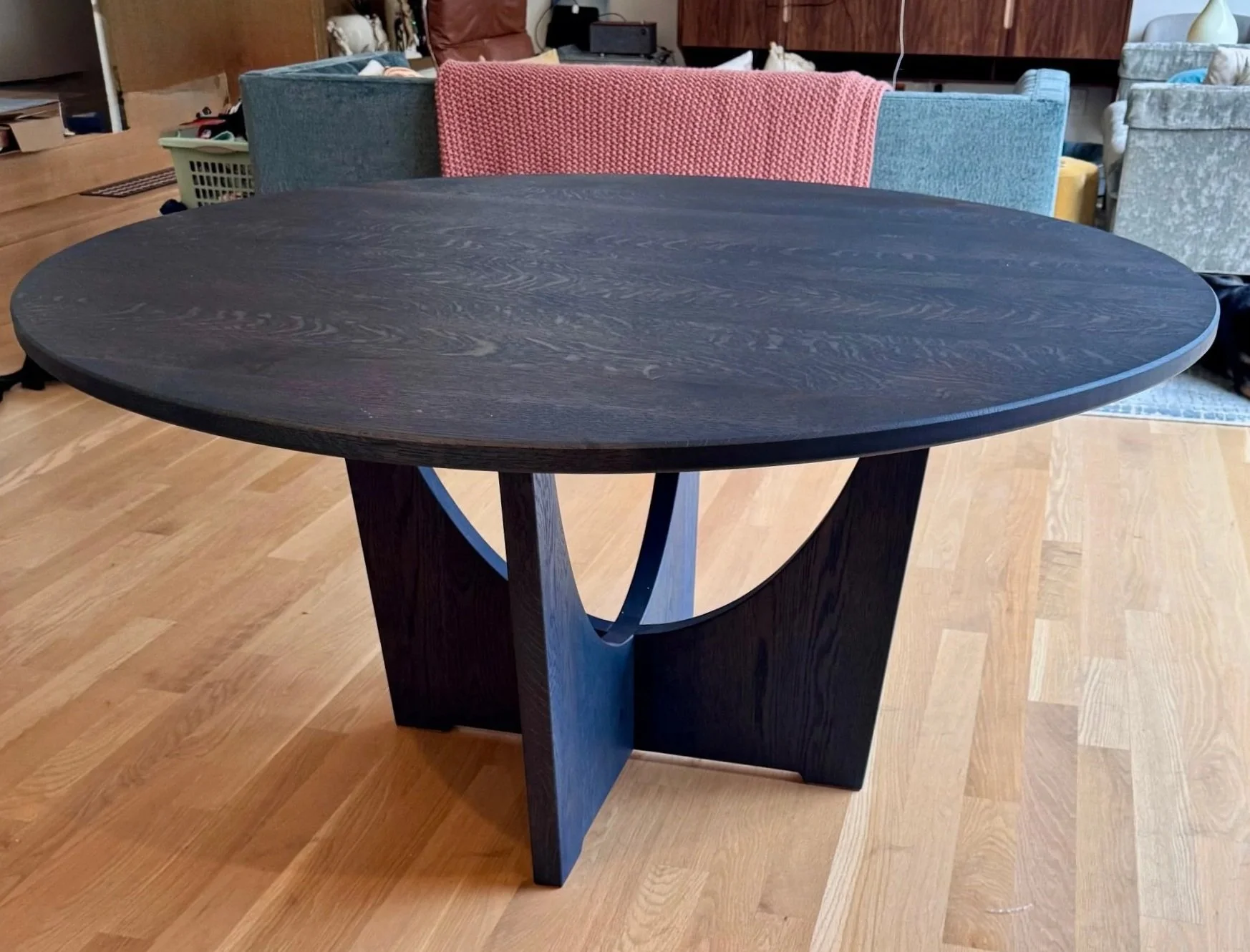 A round white oak dining table, custom design and build, with midnight blue Rubio monocoat finish. 