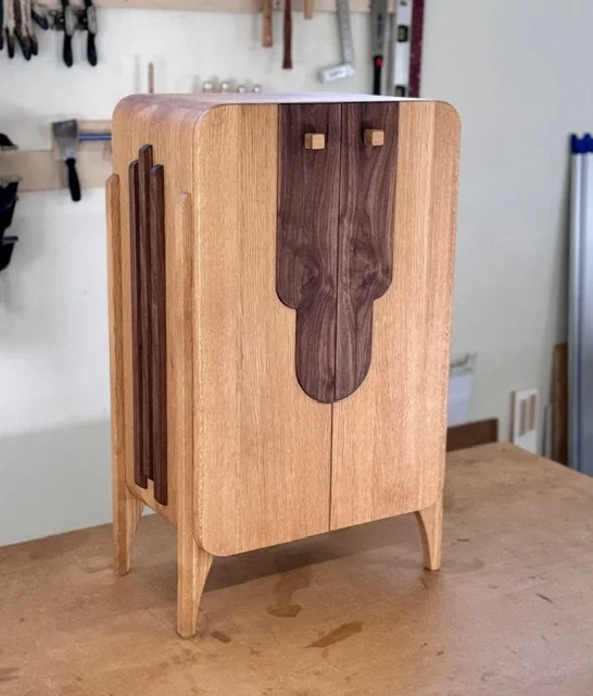 Attaboy whisky cabinet in white oak with walnut accents