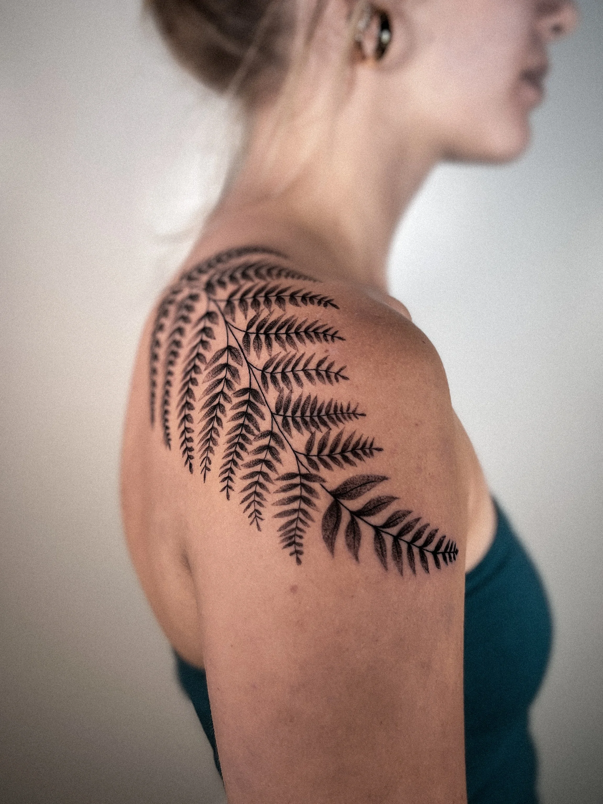 fine line stipple black and gray fern wrap feminine shoulder piece botanical tattoo by bobbi stalnkaker