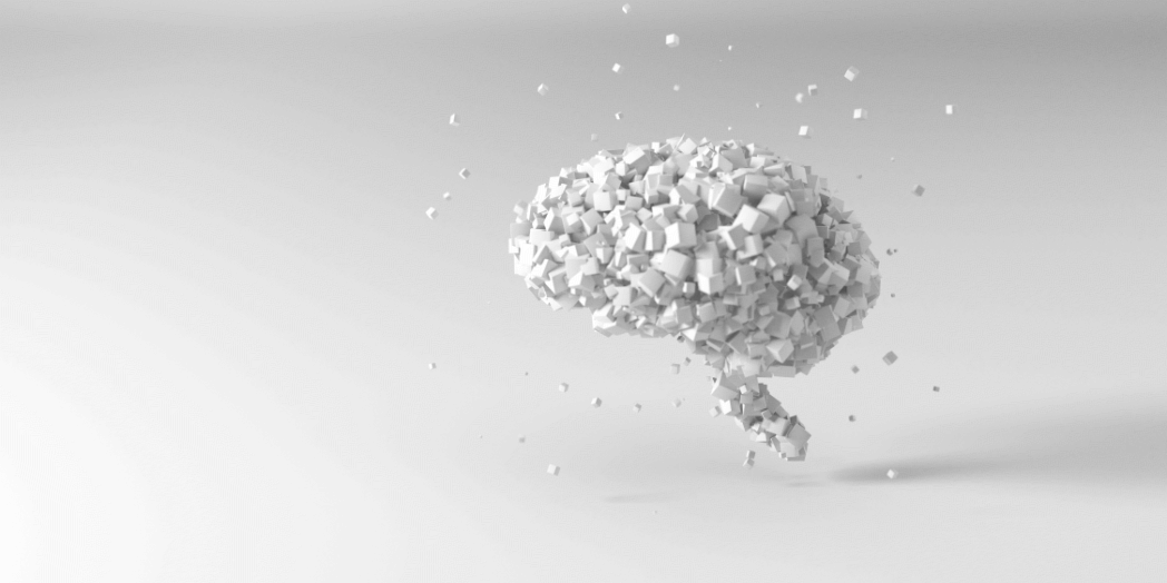 A digital illustration of a human brain made of small white cubes, with some cubes floating away, on a light gray background.