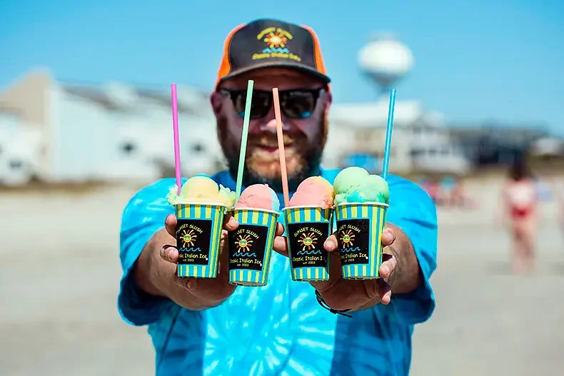 Colorful Italian ice from Sunset Slush enjoyed on the beach in Oak Island, North Carolina.