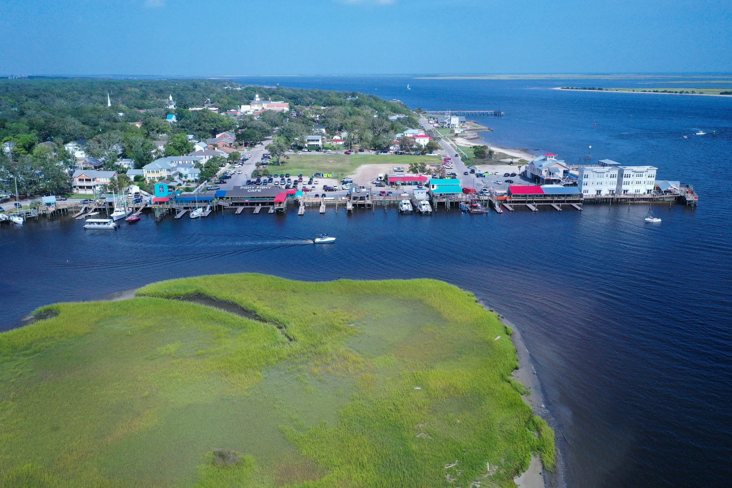 Aerial view of Southport's waterfront, marinas, marshes, and downtown area along the Cape Fear River.